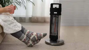 electric heater next to human legs with long socks